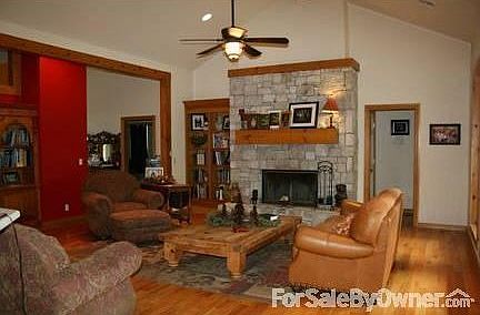 Another view of living room
						:
						The hand-laid stone fireplace is the focal point of this living room.