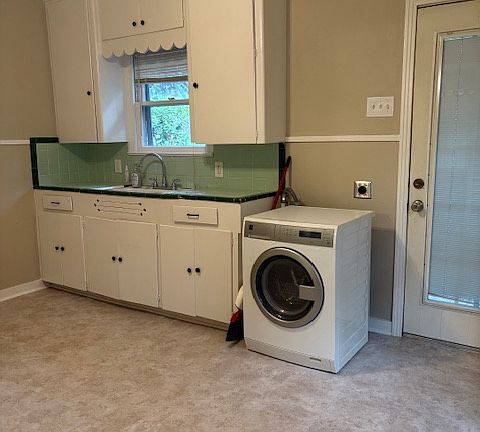 Kitchen area with washer shown for your use, dryer in the garage.