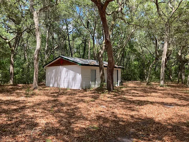 AWESOME Separate workshop. Concrete floor, full size single garage door and standard door entrance. Has electricity and water off side building. Build in workshop and shelving. Truly everyman's goto place on the property.