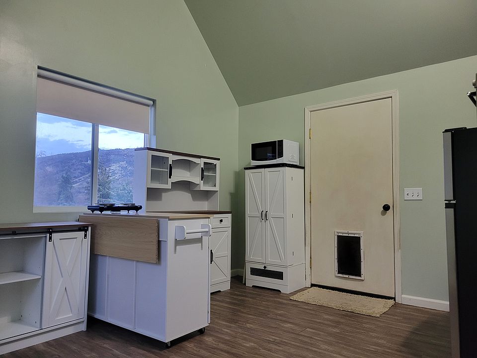 Front door with dog door leading to private fenced yard. Mountain views from living room and kitchen area.