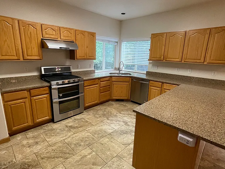 Tile in kitchen and laminated wood in the family room.