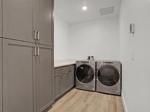 Laundry Room with Built In Cabinets for More Storage and Folding Counter Top