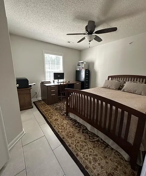 Bright queen bedroom with large desk, printer, filing cabinet and lots of room