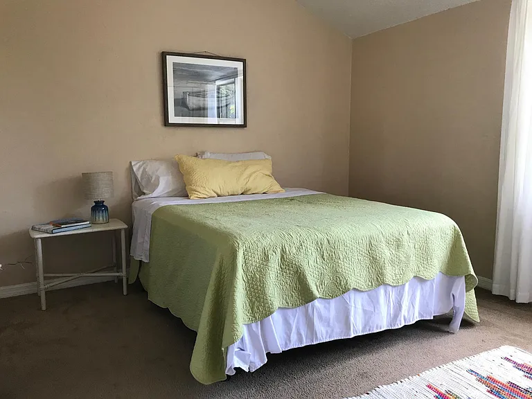Large (12x14 ft) North facing bedroom with vaulted ceilings and ceiling fan.