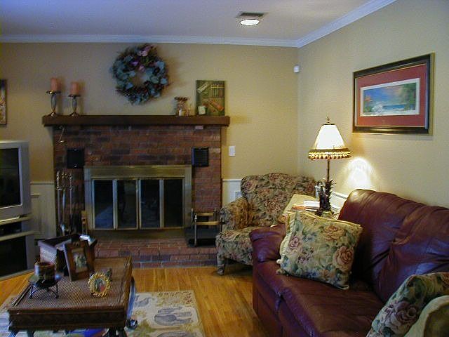 Lovely Family Room with Brick Fireplace and Recessed Lighting 