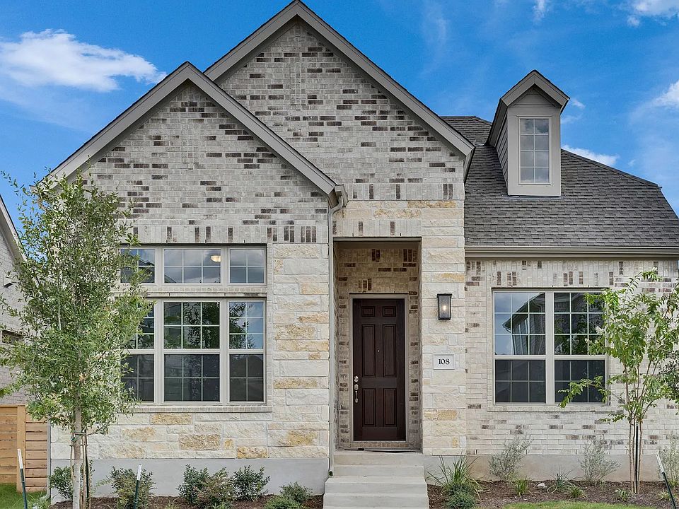 Revel in the exquisite blend of brick and stone facades, complemented by elegant dormer windows in a