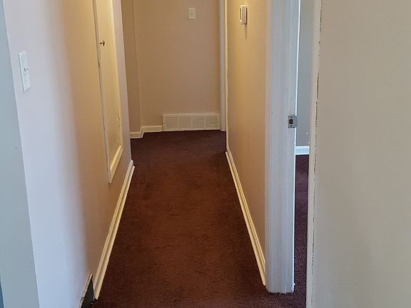 Hallway to bathroom and beds