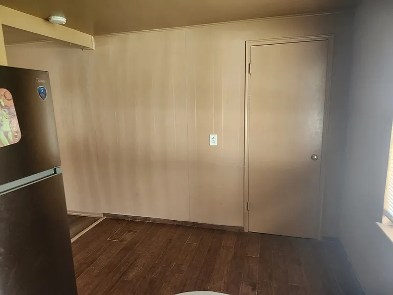 Kitchen area where a small dining table could fit and the dryer/pantry room.