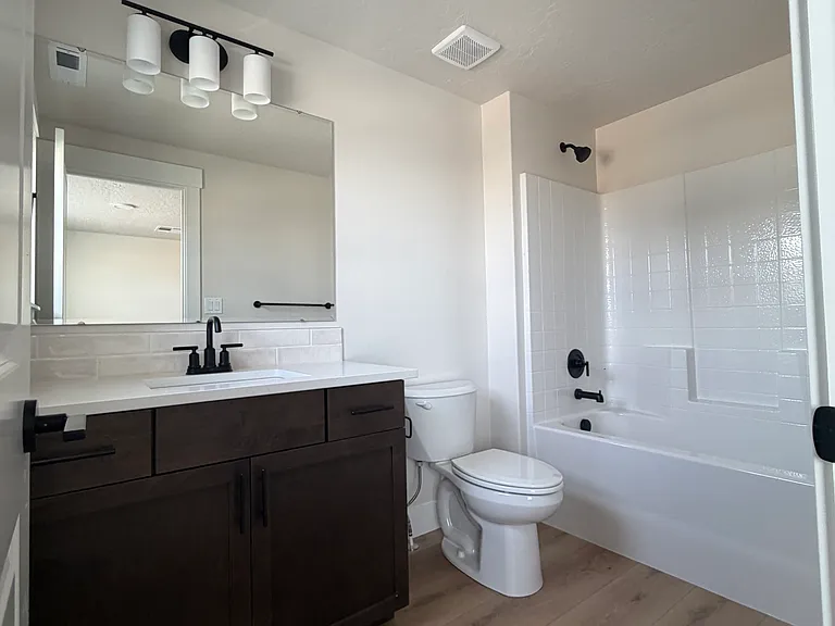 The upstairs primary suite offers a private and spacious retreat, complete with a large walk-in closet and a full en-suite bathroom. Thoughtfully designed for comfort and convenience.