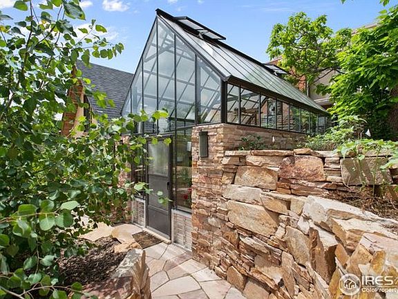 The attached greenhouse is a shared space with the owner. There is plenty of space for keeping plants and sowing seeds. Year round gardening potential!