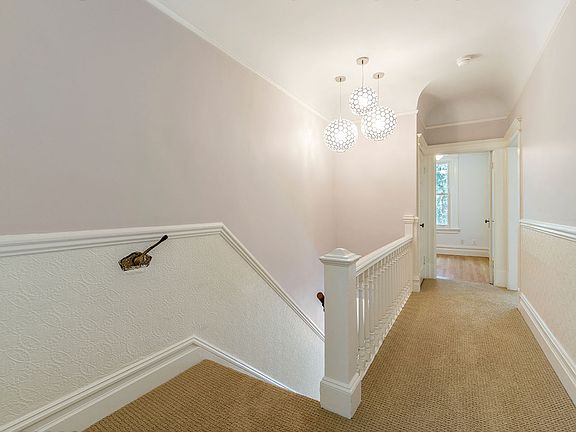 4th bedroom and closet seen at end of this hallway, it is small but fits a twin bed. Also great as an office.