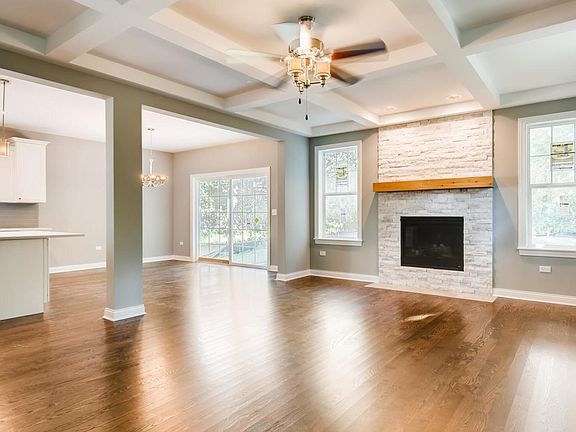 Hardwood floors, coffered ceiling, stone fireplace
