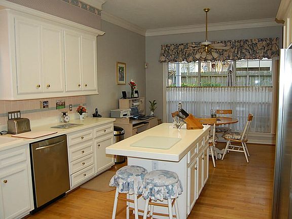 Island Kitchen with stainless steel appliances, white 42" cabinets