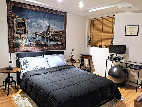 bedroom with new wood floors through out apartment.