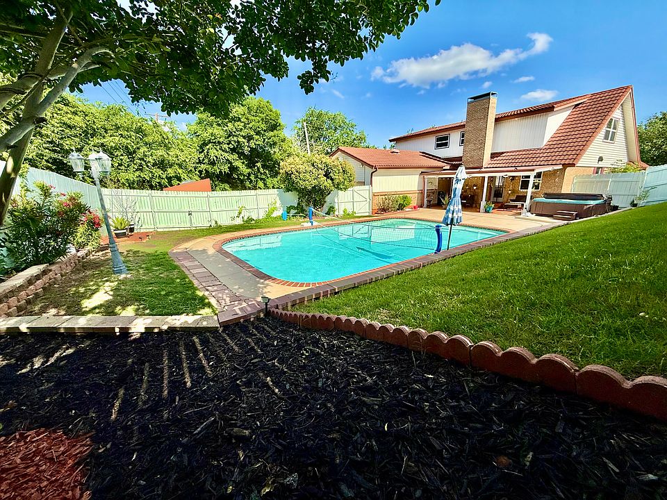 Fenced backyard with pool and hot tub