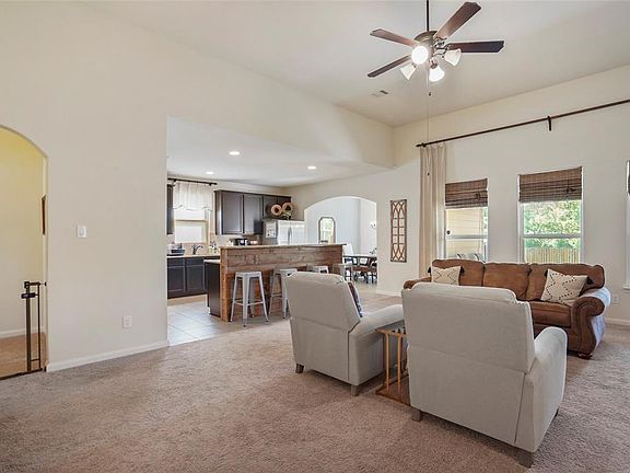 You can see into the kitchen from this shot and the hall on the left leads to two more secondary bedrooms and the other full bathroom.