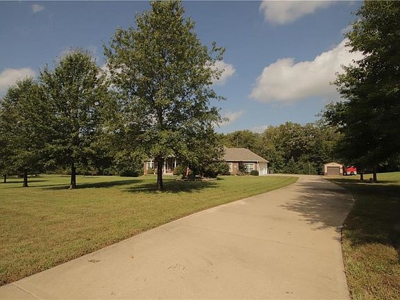 Plenty of parking for your guests on this concrete driveway leading to the 3 car garage and separate outbuilding.