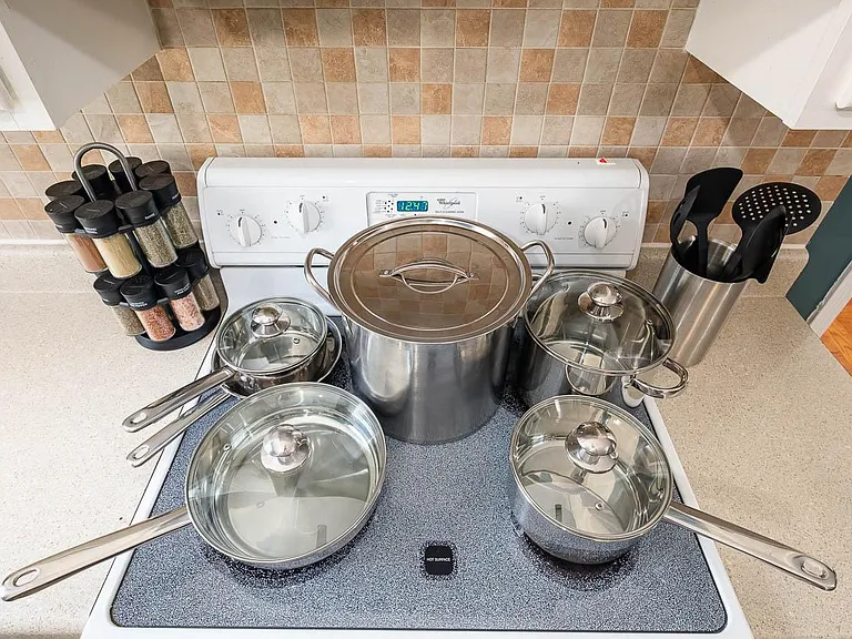 Sprice rack and stainless steel cookware.
