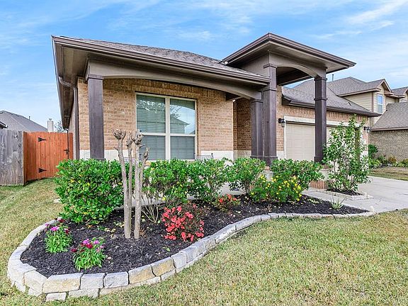 The well kept flower beds adds beauty to the home.