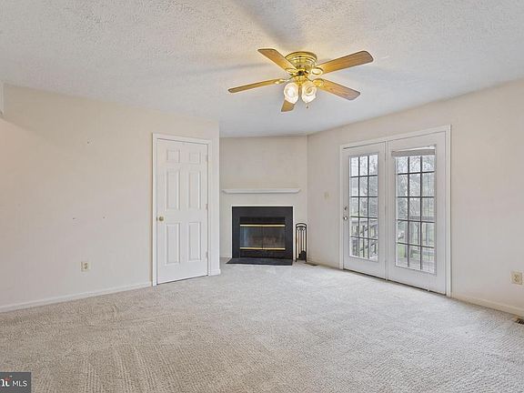 The living room includes a wood-burning fireplace