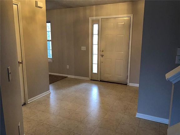 Another view of large foyer, which opens up to not only the living room/dining area, but also leads to double car garage, laundry room as well as the family room and kitchen. The side light also makes the entry way much brighter!