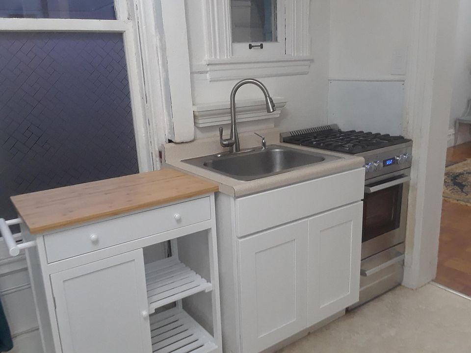 There is a countertop and cabinets opposite the stove. It is a small but adequate cooking area.