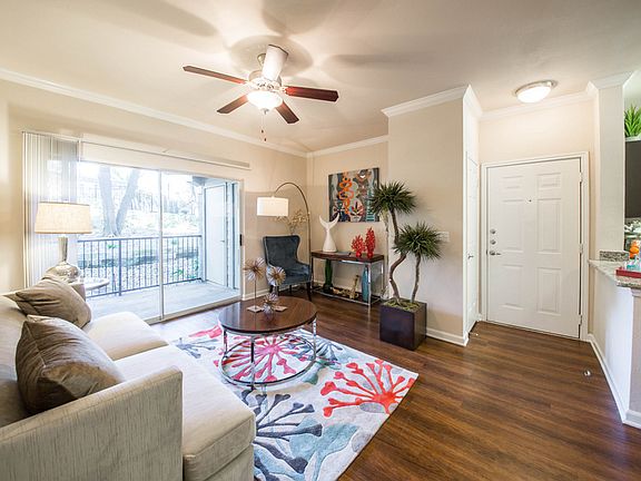 Living room with wood-style floors and balcony/patio entrance,