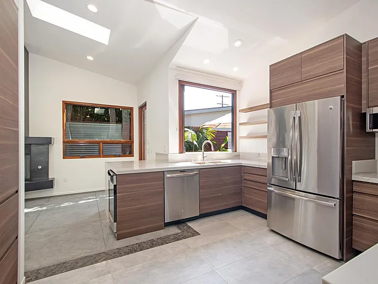 Kitchen with Caribbean bar window open over Kitchen sink onto back patio