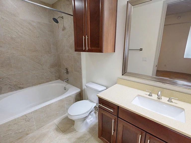 Apartment Bathroom with large soaking tub and Tile Flooring.