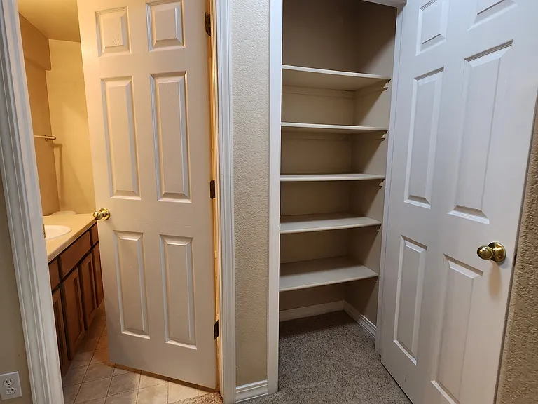 Downstairs Bathroom and Linen Closet with is situated in the hallway between the 2 downstairs bedrooms
