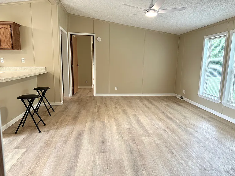 Great room living area. New easy to care for vinyl wood plank flooring throughout, large windows and 2 bedrooms and bath on that side.