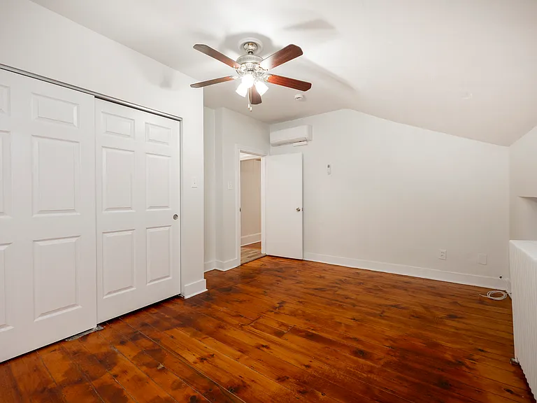 primary bedroom with oversized closet, ceiling fan, and mini split for AC
