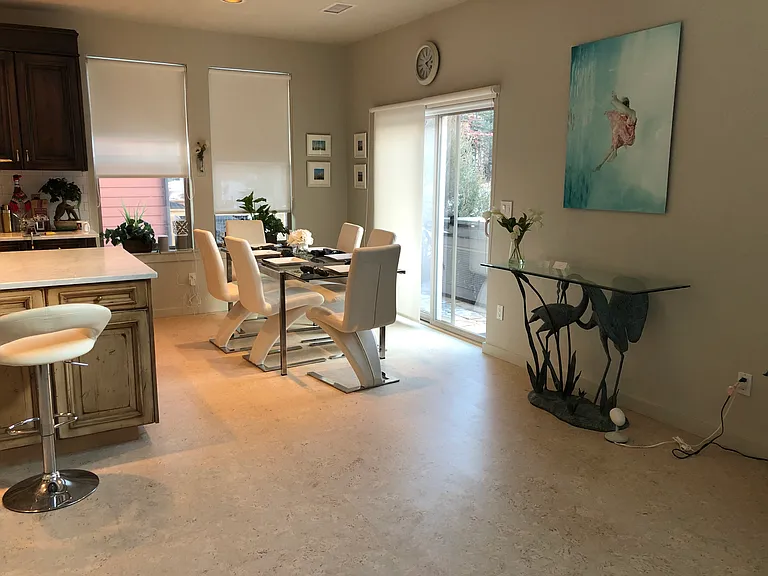 Dining with a sliding glass door leading to the back patio with hot tub and BBQ grill