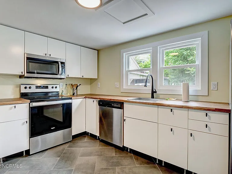 Fully renovated kitchen! Stainless steel appliances, butcher block counters, and soft-close drawers/cabinets.