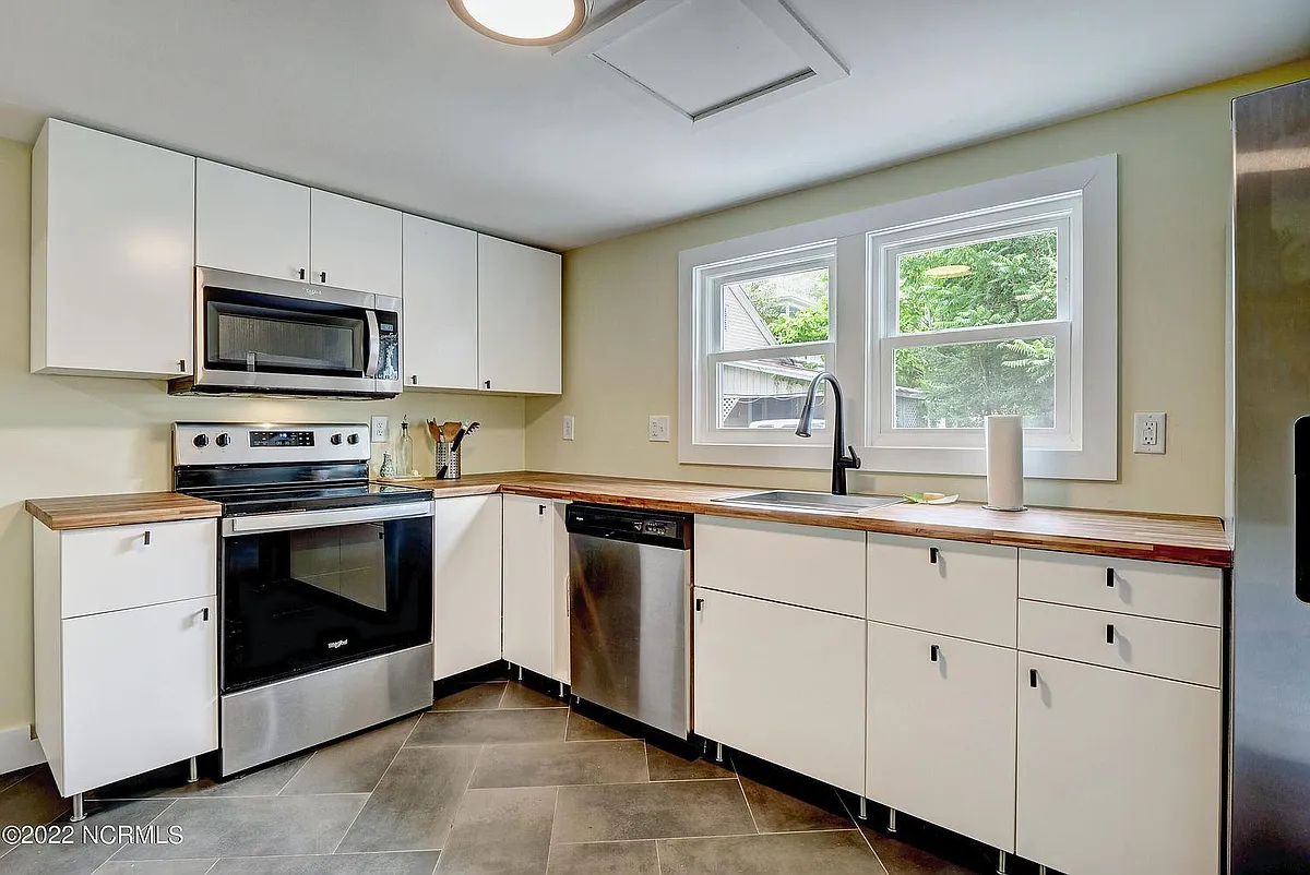 Fully renovated kitchen! Stainless steel appliances, butcher block counters, and soft-close drawers/cabinets. - 416 Wright St
