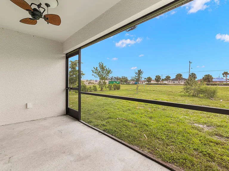 Lovely outdoor lanai fully screened in with a cool fan and light combo