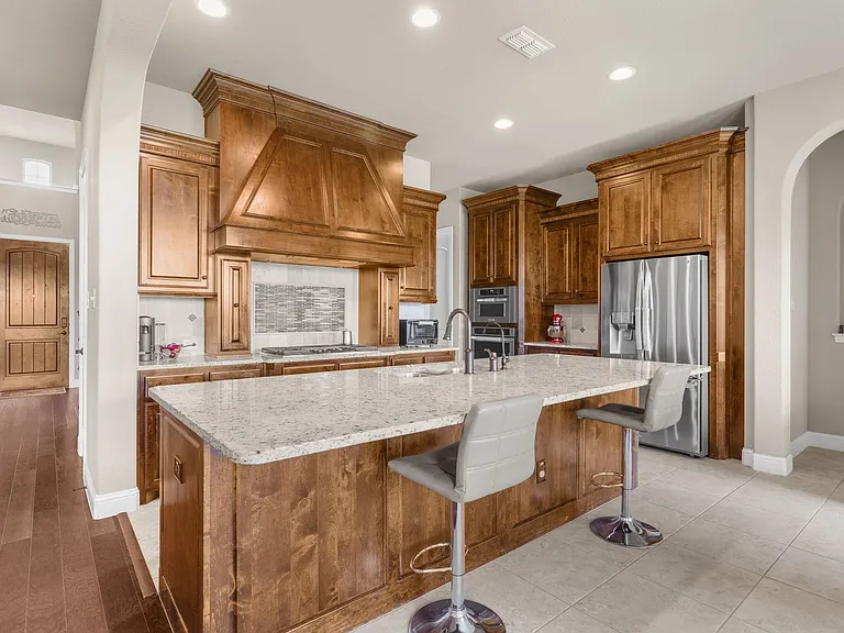 Designed for today's lifestyle, the family chef will love the marvelous kitchen complex--beautiful wood cabinetry with spice pull doors flanking the venthood, noteable cabinet & pantry storage, granite countertops + stainless appliances including the refr