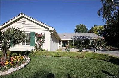 Gorgeous landscaping throughout with cobblestone accents