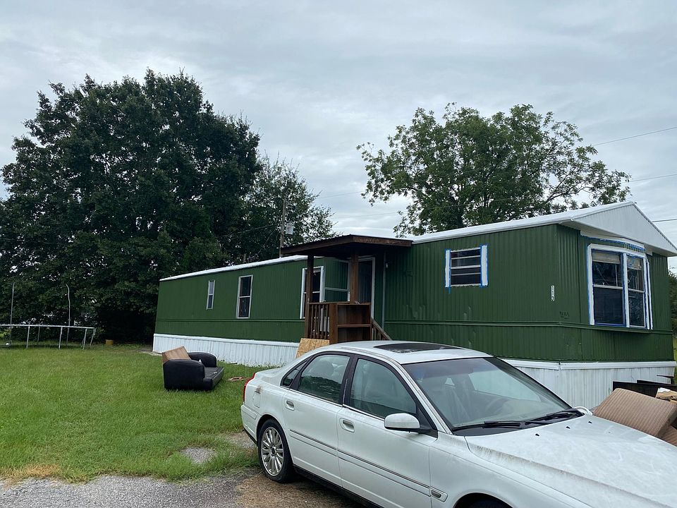 Front of property with 2 paved parking spots and covered entrance