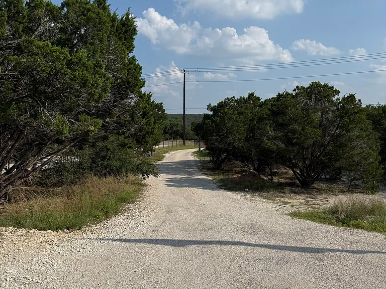 View looking from home down driveway towards gate