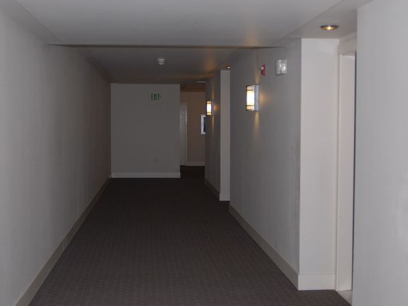 Hallway leading to apartment is unusually wide