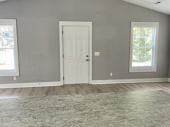 Vaulted living room with ceiling fan