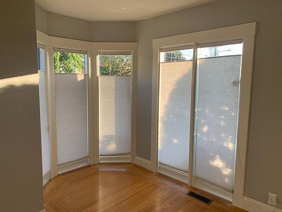 Bay windows with lots of natural sunlight. Top down bottom up cellular shades.