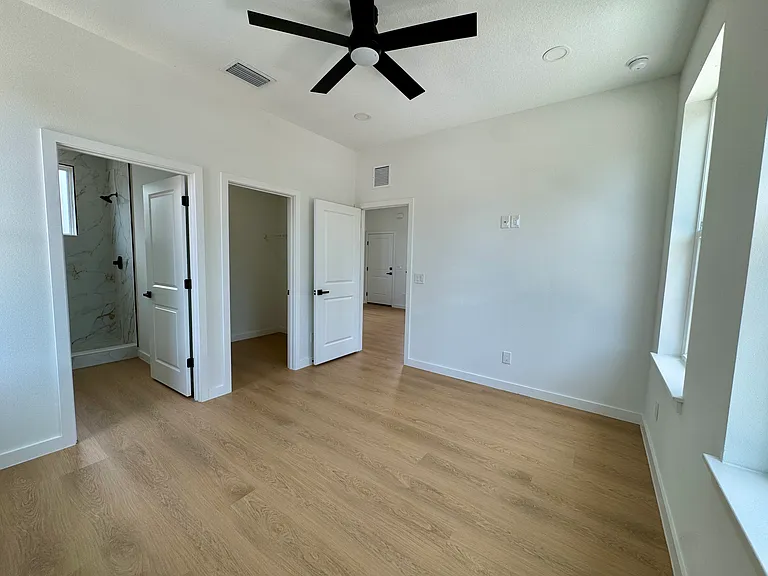 Spacious bedroom with ensuite bathroom and walk-in closet.
