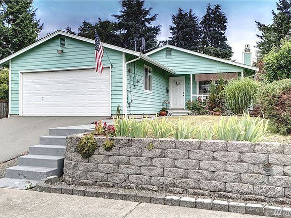 Nice curb appeal ~ Nice driveway ~ Nice landscaping...  And a RAMBLER!  With a 2 car garage!  And a home that's not a 100 years 