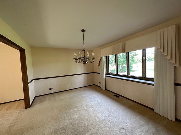 dinning room next to the living room with the view of the backyard/ pond/ park