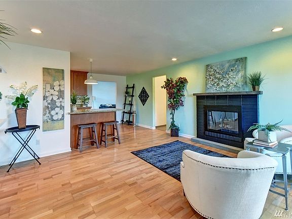 Step in to the living room with beautiful hardwood floors and a wood burning fireplace.
