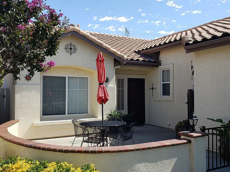 Generous front courtyard with fountain and security screen door.