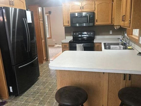 Black stainless steel appliances - including dishwasher.