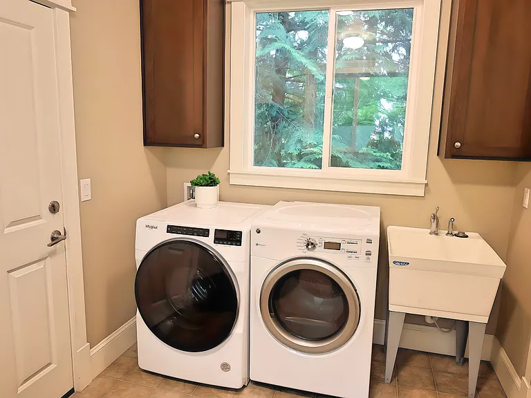 The washer and dryer located in the mud room, which is between the garage and the kitchen area.